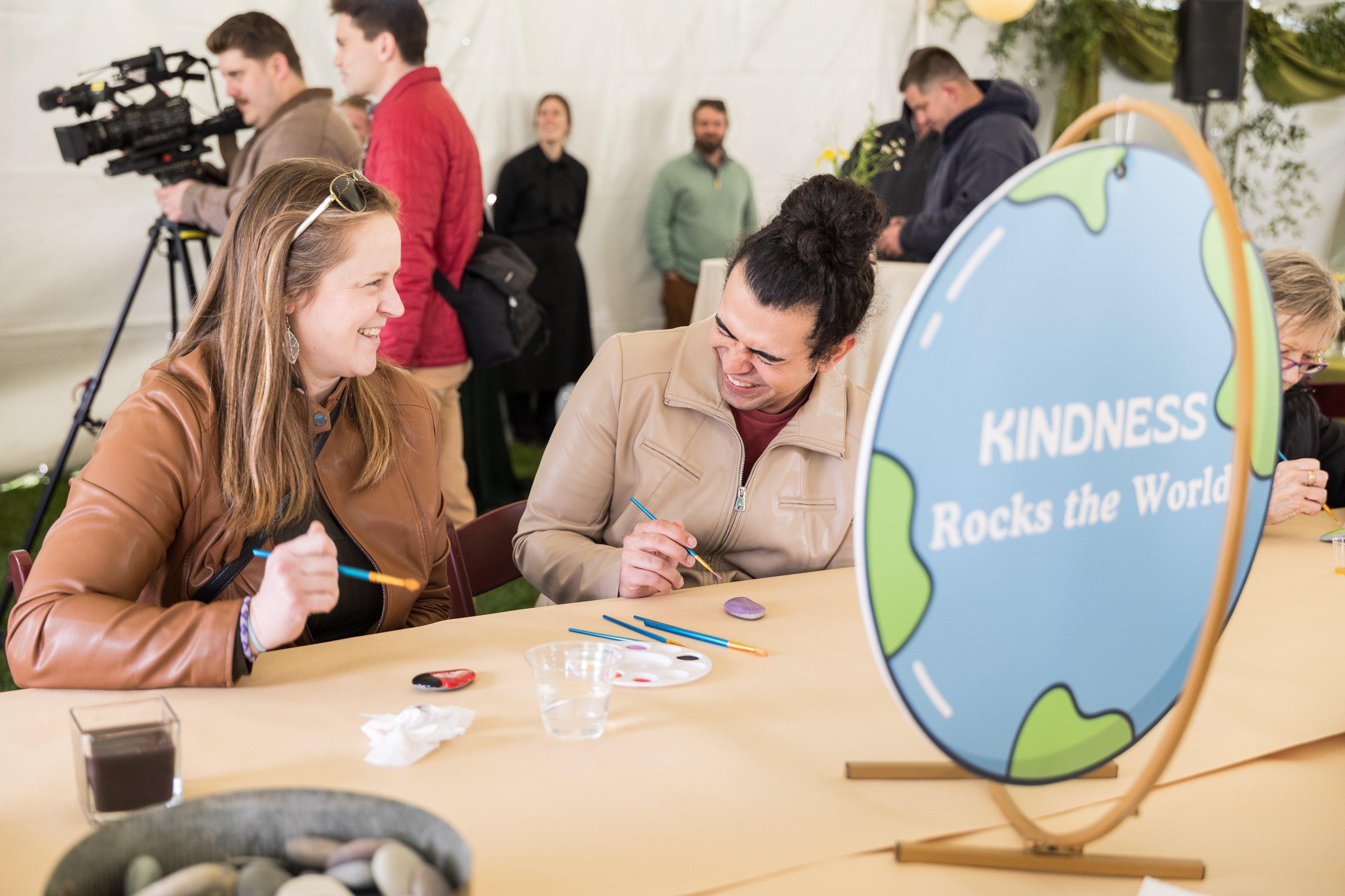 Attendees enjoying Earth Day event at Greenfield, painting rocks 