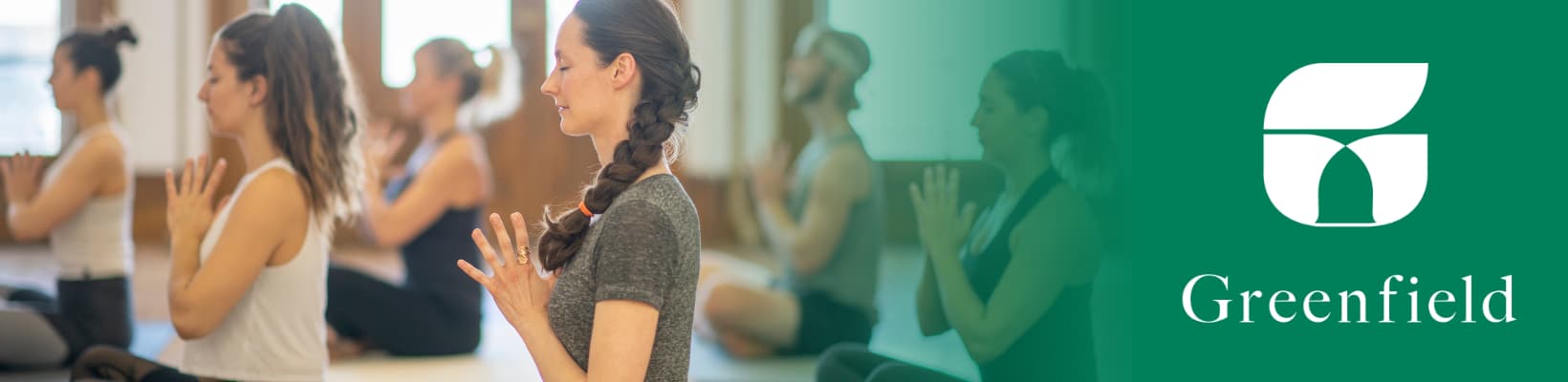 Various adult men & women practicing yoga 