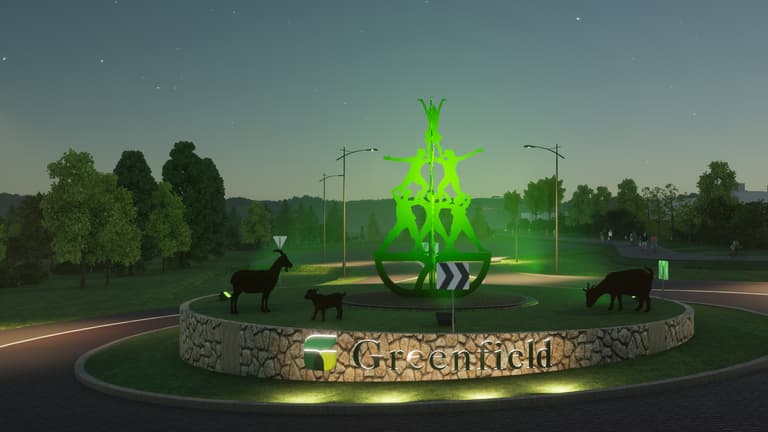 Roundabout art sculpture at night with green up lighting. 