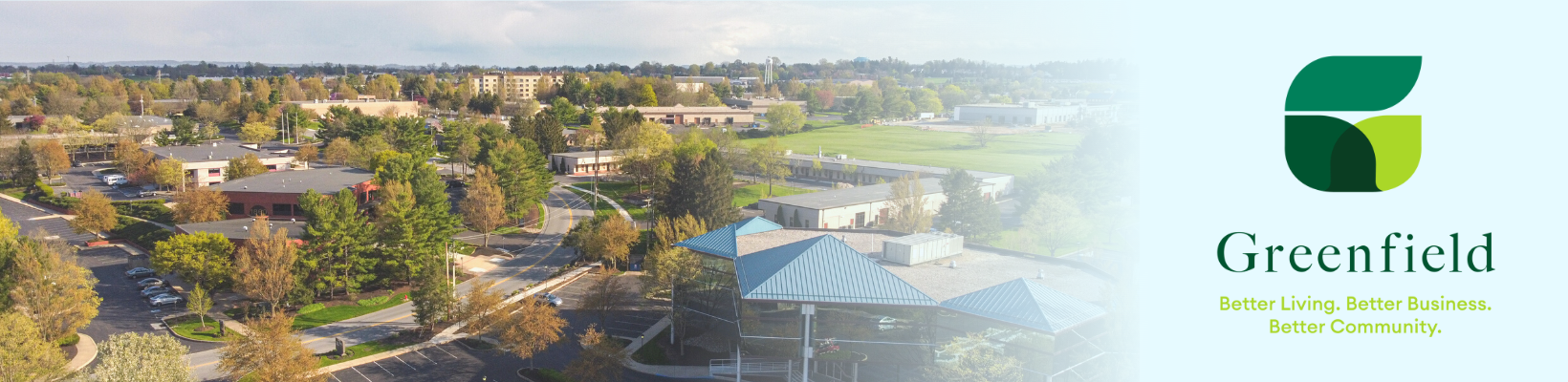 Drone photo of Greenfield businesses next to Greenfield logo