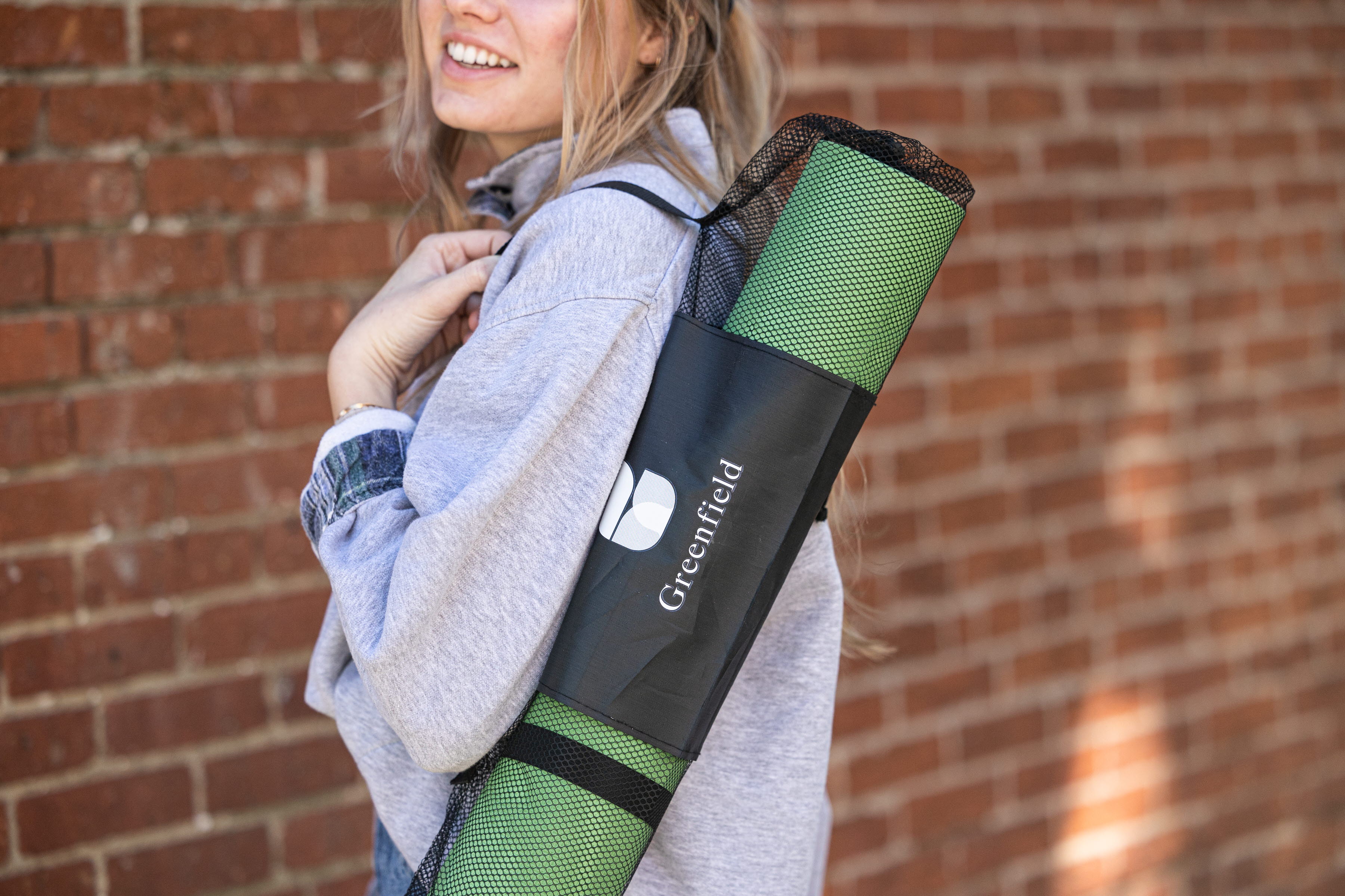 Photo of Greenfield branded yoga mat. 