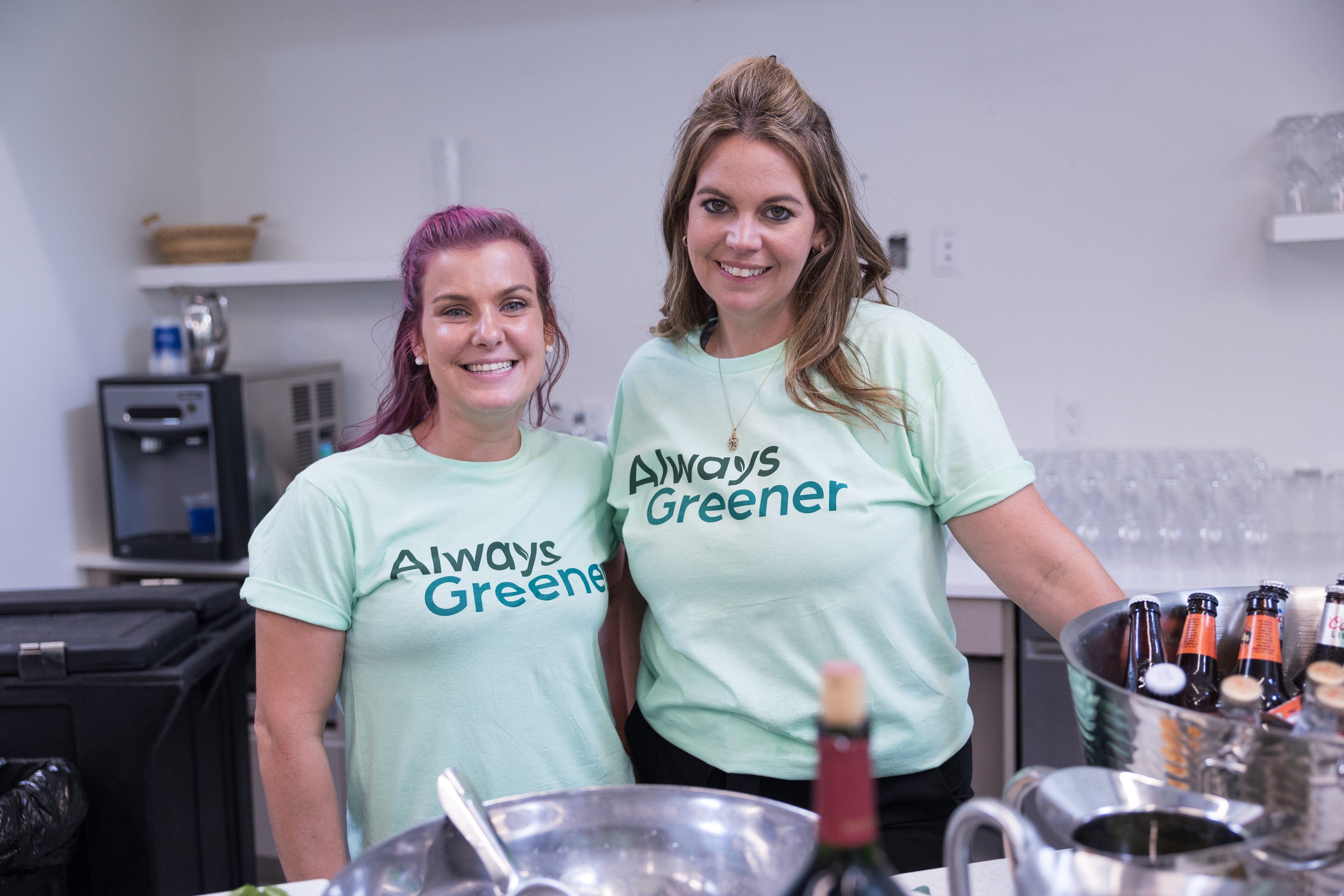 Two adult women wearing Always Greener branded shirts 